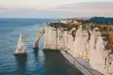 White chalk cliffs and sea arches at Etretat on the Normandy coast at golden hour
