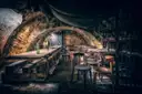 An old vaulted stone cellar with wooden tables and chairs