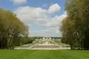 The formal gardens of Vaux-le-Vicomte stretching away between tall trees