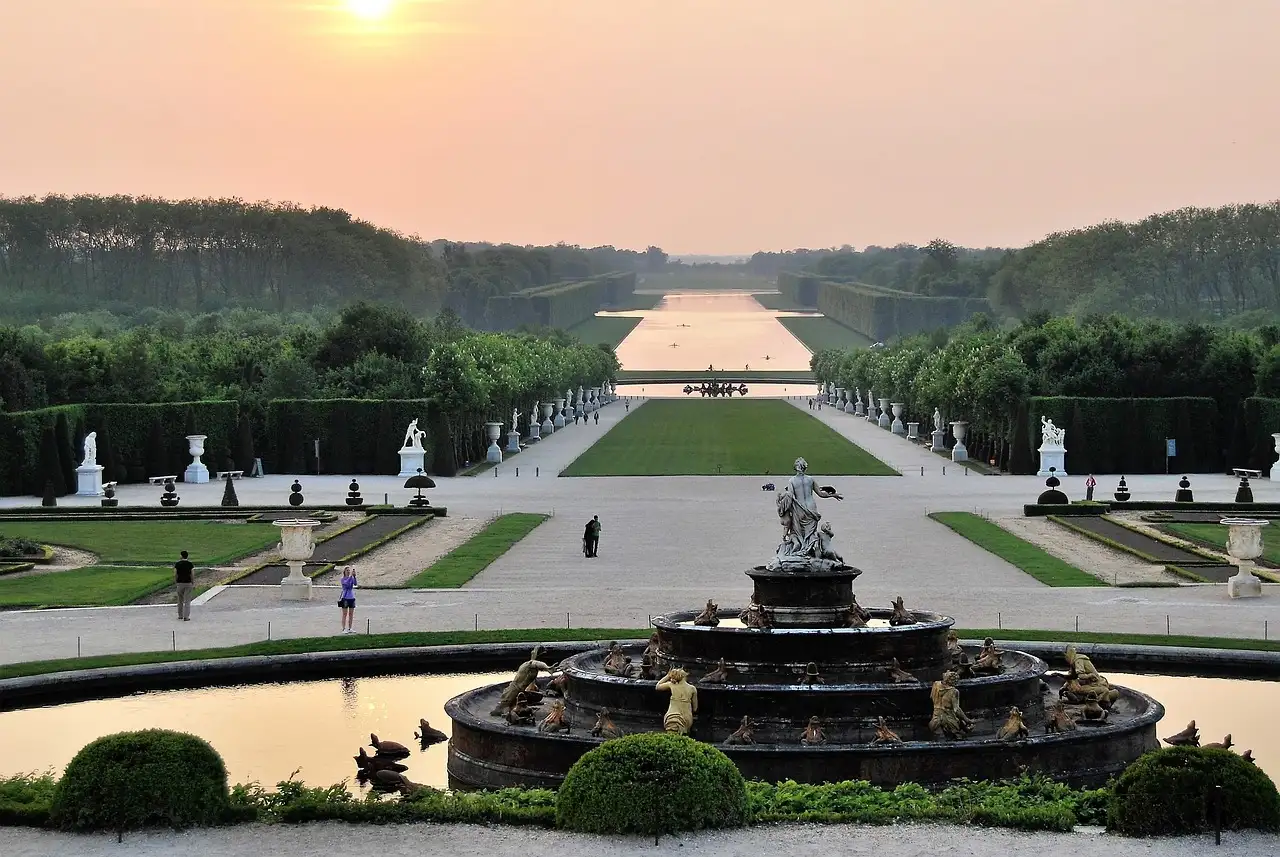 The Latona Fountain and the garden avenue to the Grand Canal at Versailles at sunset