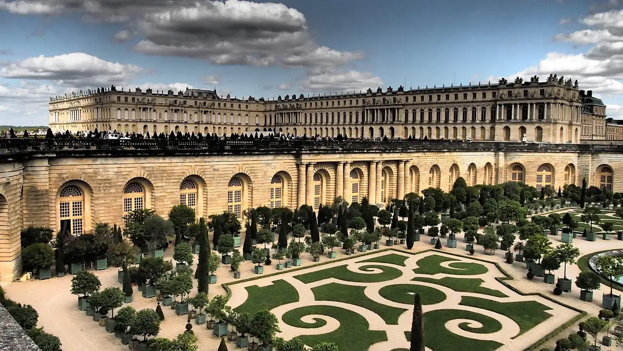 The Orangerie parterre's scrolled hedges below the south wing of the Palace of Versailles
