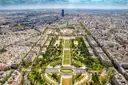 View from high on the Eiffel Tower down the Champ de Mars, with Paris stretching to the horizon