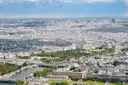 View from the Eiffel Tower across the Seine and its bridges to the rooftops of Paris