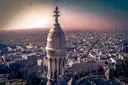 View from the Sacré-Cœur dome over the rooftops of Paris in hazy evening light